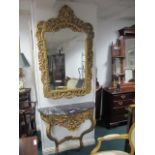 A CONTINENTAL GILTWOOD AND MARBLE CONSOLE TABLE AND MIRROR the rectangular plate within a pierced