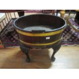 A FINE GEORGIAN MAHOGANY AND BRASS BOUND WINE COOLER of oval outline with brass carrying handles on