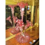 A VICTORIAN RUBY GLASS AND CLEAR GLASS FOUR BRANCH EPERGNE raised on a circular dish with wavy rim