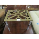 A VICTORIAN BRASS AND POLISHED STEEL TRIVET the rectangular pierced top raised on baluster legs