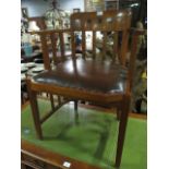 AN ARTS AND CRAFTS STYLE OAK TUB SHAPED LIBRARY CHAIR the curved top rail with vertical splats and