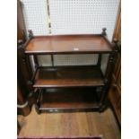 A VICTORIAN MAHOGANY THREE TIER DUMB WAITER each rectangular moulded shelf joined by baluster