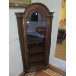 A WALNUT AND MAHOGANY CORNER CABINET by "Butlers of Dublin" the rectangular arched pediment above a