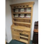 A PINE DRESSER the outset moulded cornice above four open shelves the base with frieze drawers and