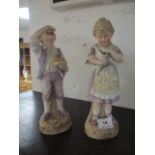 A PAIR OF BISQUE FIGURES modelled as a young girl and her companion she holding a conch shell he