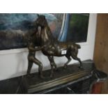 A BRONZE FIGURE modelled as a horse and handler shown standing on a naturalistic base 45cm (h) x