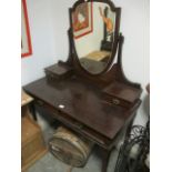 AN EDWARDIAN MAHOGANY SHIELD SHAPED MIRROR with brass handles 157cm (h) x 108cm (w) x 54cm (d)