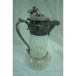 1920s/30s claret jug with lion and shield finial, chased grape vine decoration with clear twist