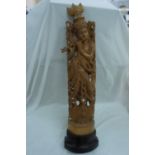 Far Eastern well carved wood figure of a man in headdress standing on a lotus blossom, height 25ins