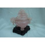 Chinese rose quartz carved two-handled urn with dragon finial and lion mask ring handles, lion paw