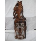 Solomon Island carved hardwood mask with sail fish to top, mother of pearl inlay to mask below, 28