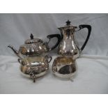 GV four piece hand-beaten silver tea service with scroll and ebony handles on splayed feet, London