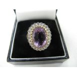 Oval amethyst and diamond ring on a gold shank, Size O