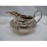 Victorian chased silver cream jug with floral decoration