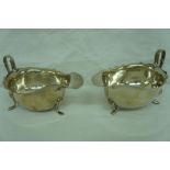 Two silver sauce boats with shaped borders Birmingham 1932 and Sheffield 1956 6.5 ozt.