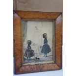 Charming 19thC coloured silhouette of two girls playing, 8 x 6 ins., in a birds eye maple wood frame