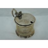 Victorian silver mustard pot of plain cylindrical form with shell thumb catch, scroll handle, London