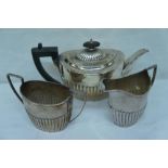 Half-fluted silver breakfast teapot, milk and sugar, Birmingham and Sheffield 1896 and London