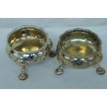 Pair of GIII chased circular silver salts with shaped gadrooned border, floral decoration to bodies,