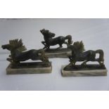 Three Chinese carved green soap stone horses applied to marble stands, length 5.6 ins.