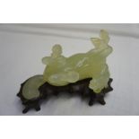 Chinese carved pale green jade horse rolling on its back on an original carved hardwood stand,