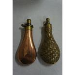 Two early 19thC copper and brass powder flasks one plain the other with diamond decoration length