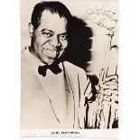 A Vintage Autographed Photograph of Louis "Satchmo" Armstrong (1901-1971) holding his Trumpet,