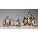 A Rococo-Style Miniature Gilt Bronze and Enamel Clock Garniture, 19th c., two clocks set within