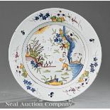 English Delft Chinoiserie Charger, 18th c., tin glaze, well with figure in a landscape, rim with