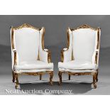 Pair Louis XV?Style Carved and Gilded Bergères, 20th c., arched foliate crest rail, padded acanthine