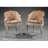 Pair of Louis XV?Style Crème Peinte Bergères, early 20th c., arched floral crest, shaped apron,