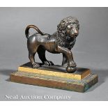 Antique Continental Patinated Bronze Figure of a Lion, paw resting on sphere, h. 4 3/4 in., w. 5 1/2