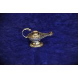 An Edward VII silver oil lamp with birds head form loop handle, the body with all-over scroll and