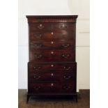 A George III mahogany chest on chest with carved pediment above two short and six long drawers