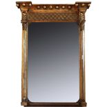 A 19th century gilt framed wall mirror with orb finial and Corinthian columns flanking the mirror
