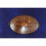 A 19th century mahogany and marquetry inlaid oval tray, the central field with fan inlay