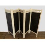 A cream painted five-fold screen with pierced top section and green embossed leather panels,