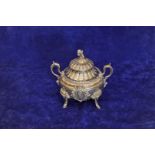 A plated twin handled tureen and cover with cherub form finial, gadrooned stylised floral