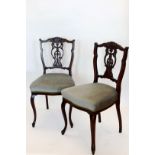 A set of four Victorian walnut dining chairs with acanthus leaf and stylised shell carved cresting