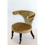 An Edwardian library chair with upholstered button back and circular seat, on turned legs and