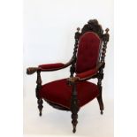 A pair of Victorian oak elbow chairs with over-stuffed arm supports and lion mask finials, over-