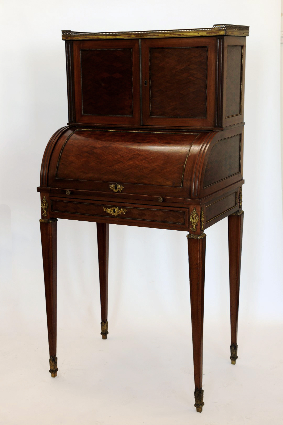 A 19th century French parquetry writing desk with three quarter pierced gallery above two panelled