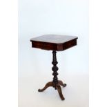 A Victorian sewing table, the hinged lid opening to reveal a compartmented interior, on a turned