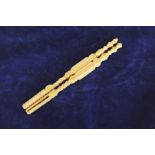 A pair of ivory needlework tools with thistle form finials and all-over carved geometric and