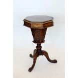 A Victorian octagonal sewing table with floral marquetry inlay to the octagonal lid, opening to