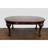A Victorian mahogany dining table with gadrooned frieze, on scroll and acanthus leaf carved cabriole