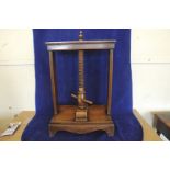 An 18th century oak and elm book press with screw central section, on a shaped plinth base. 20½ins