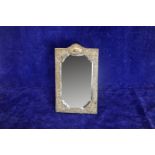 An Edward VII silver framed bevelled wall mirror, the frame with embossed rococo scroll and flower