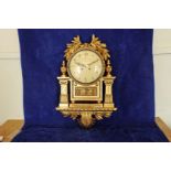 A carved gilt framed French style wall clock with pierced lyre form finial flanked by acanthus