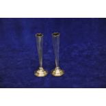 A pair of Edward VII silver spill vases with octagonal tapering stems and on stepped octagonal